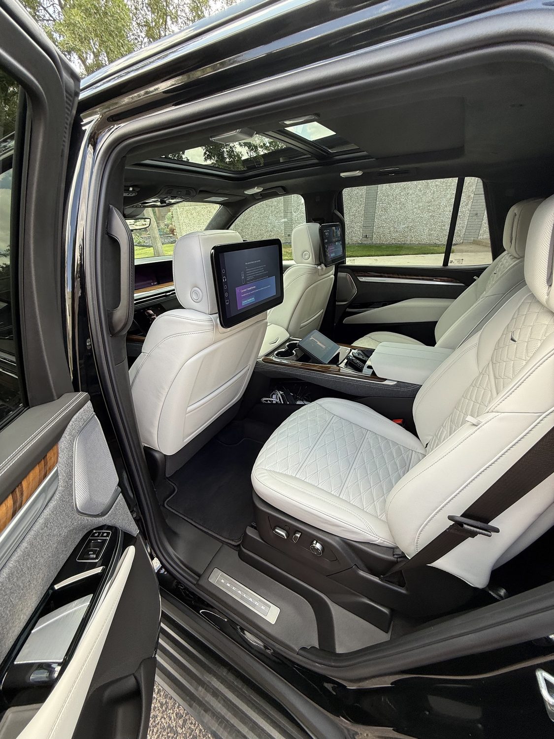 Cadillac Escalade cabin with white leather seats after an AutoX interior detail